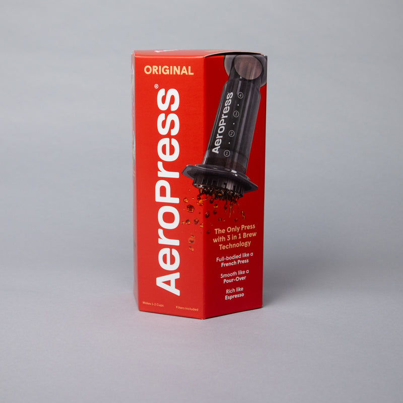 AeroPress Original Coffee Maker packaging with coffee brewing device on grey background