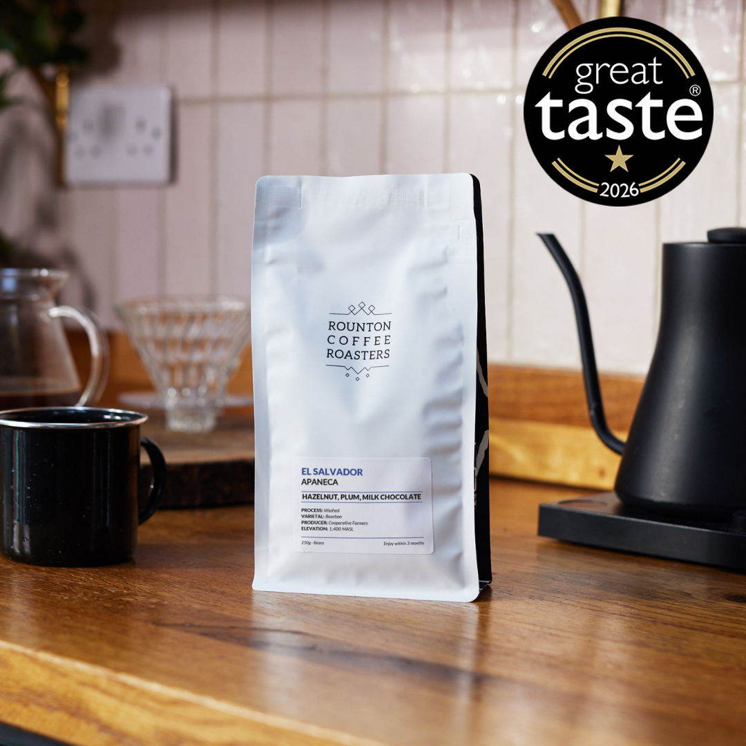 Apaneca speciality coffee beans bag beside brewing equipment