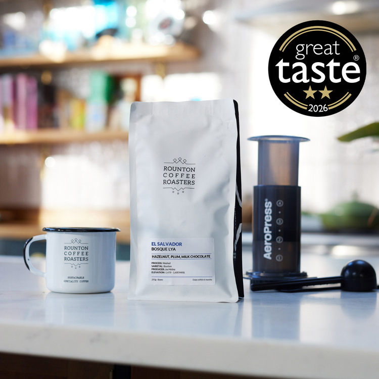 Bosque Lya coffee bag with AeroPress brewer and coffee mug