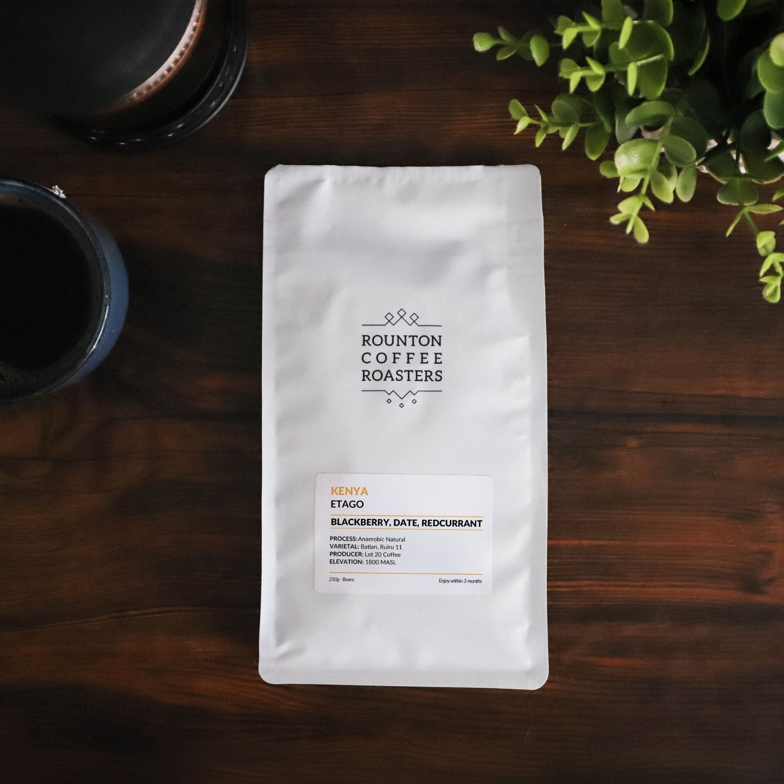 Kenyan coffee bag on a wooden table.