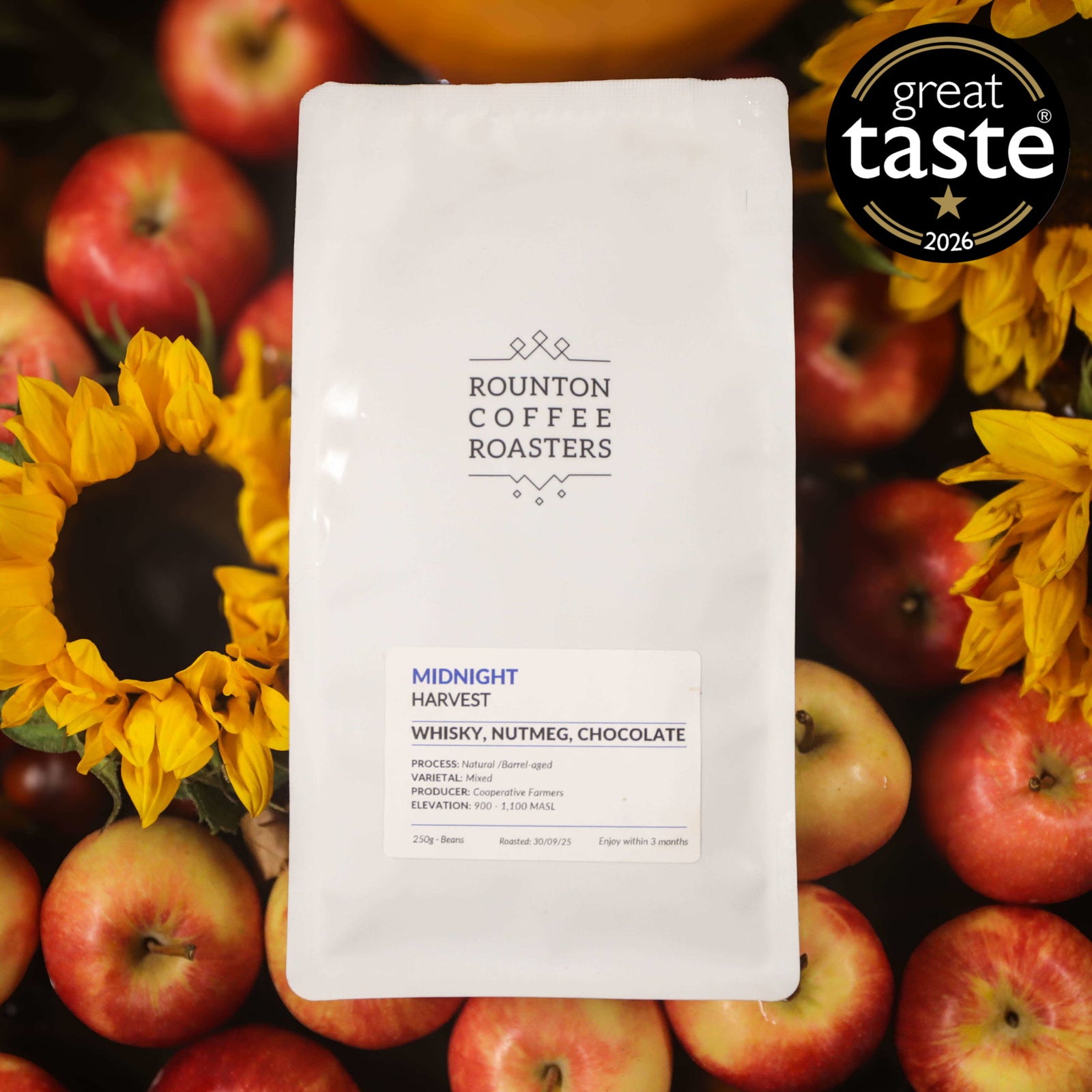 Midnight Harvest speciality coffee beans in a white bag with apples and flowers